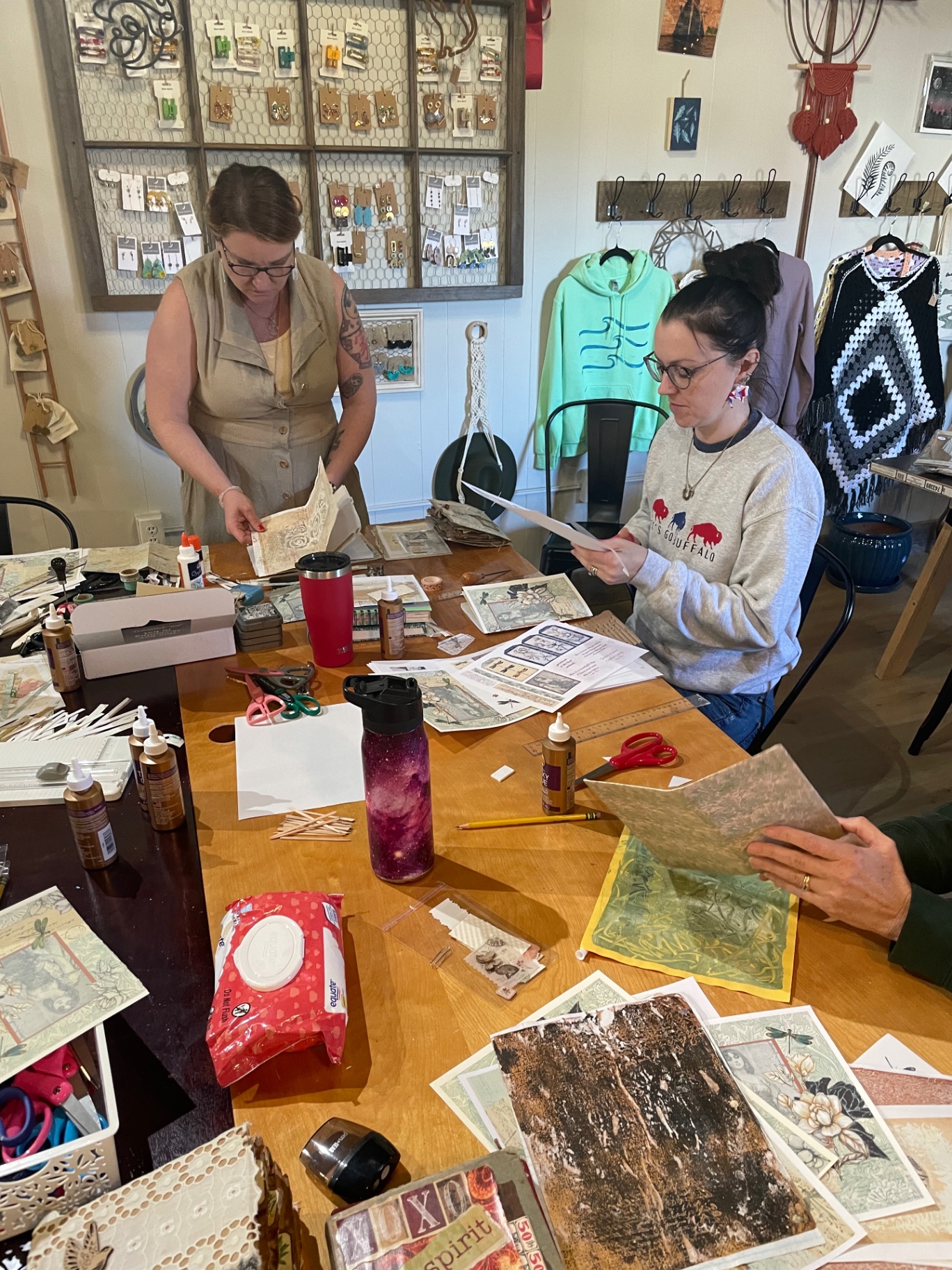 Women crafting together at a studio workshop table